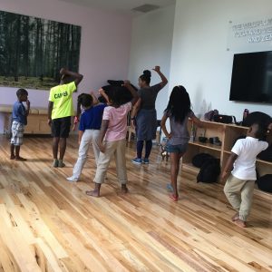 Young boys and girls in dance class with teaching artist.